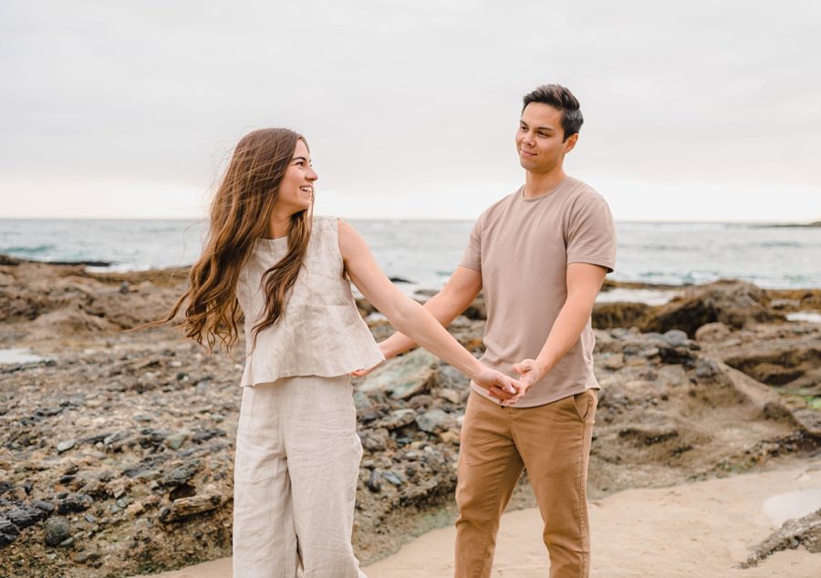 neutral beach couples portraits holding hands