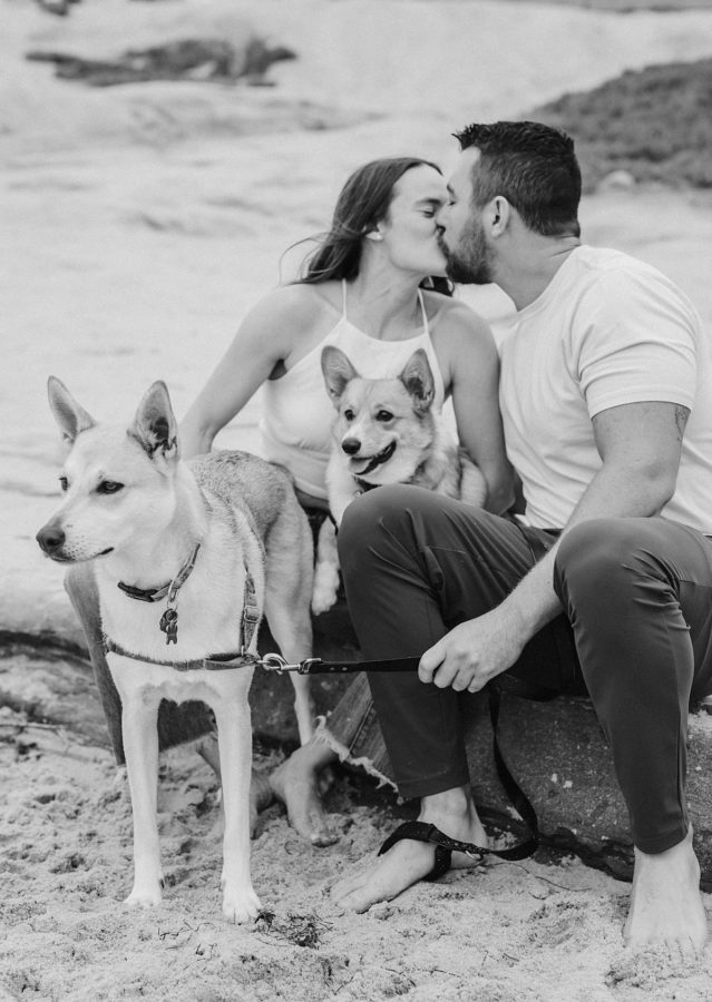 black and white couple kissing dogs