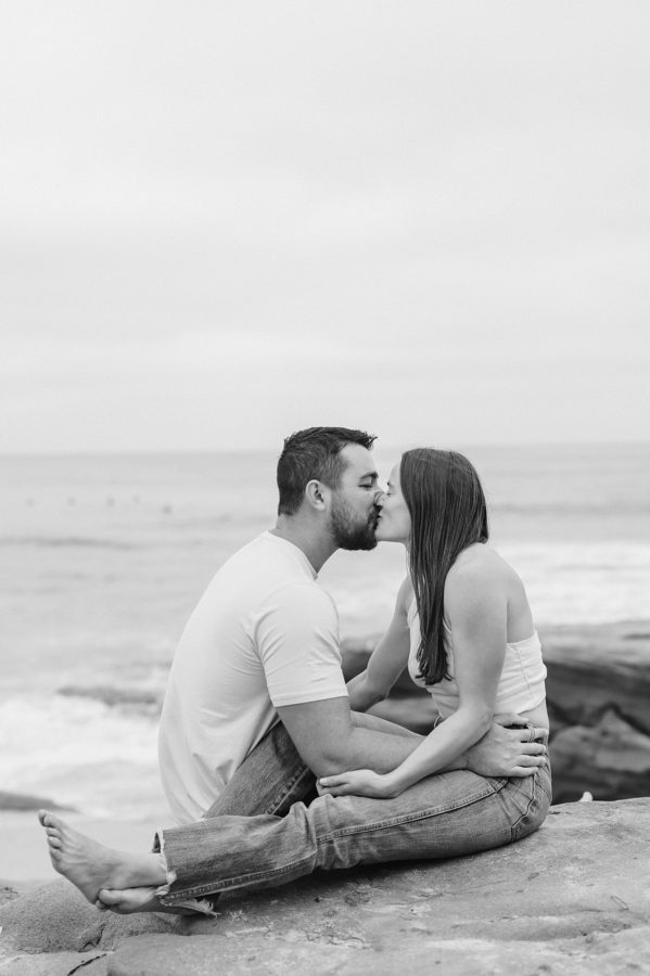 black and white couple kissing beach