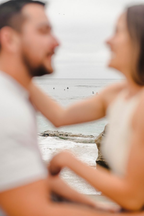 couple hugging beach background