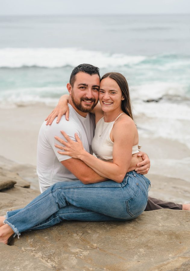 smiling couple hugging windansea beach california