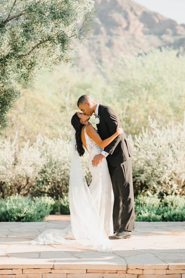 bride and groom kissing el chorro backdrop