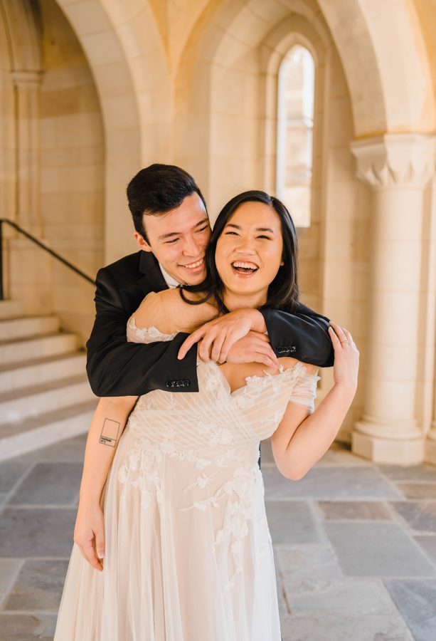 bride and groom hugging smiling cathedral