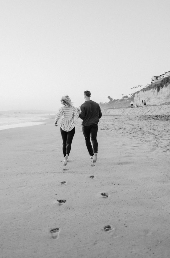 black and white orange county beaches photo couple holding hands