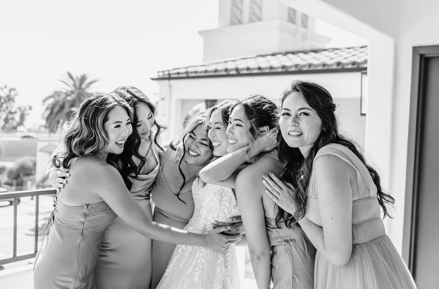 black and white bride and bridesmaids hugging