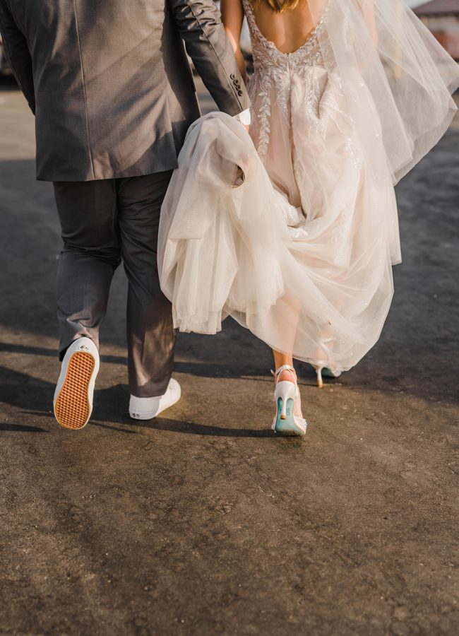 bride and groom walking wedding dress details