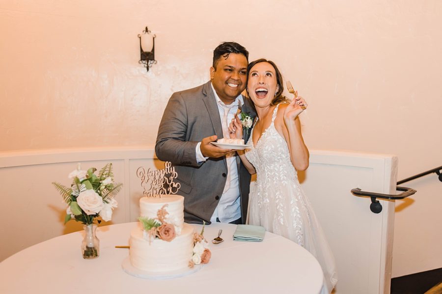 bride and groom smiling reception wedding cake 