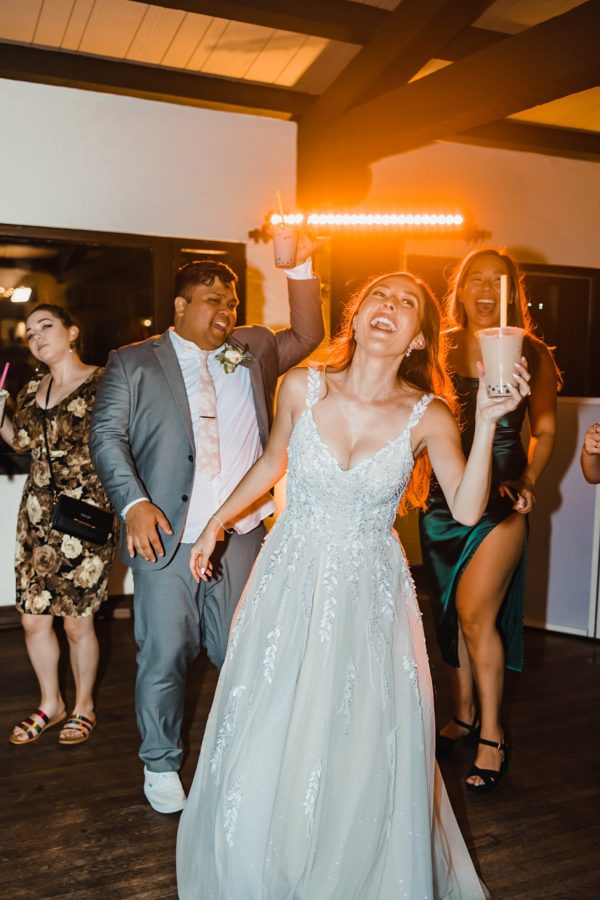 bride and groom dancing smiling