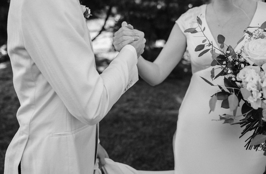 black and white bride and groom holding hands