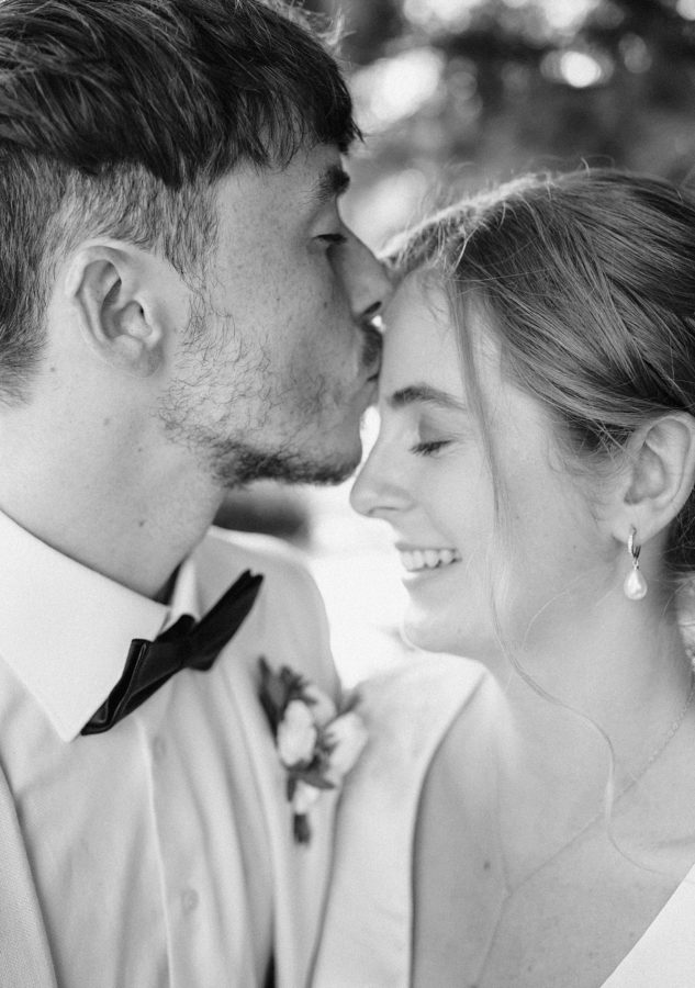 black and white groom kissing bride wedding details