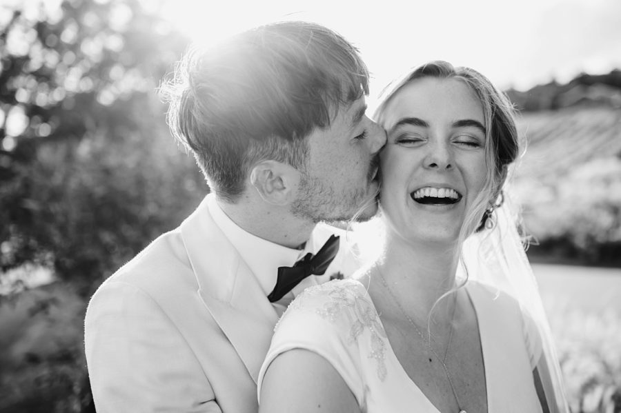 black and white groom kissing bride