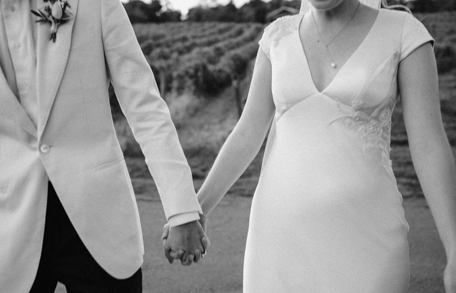 intimate bluemont vineyard wedding black and white holding hands