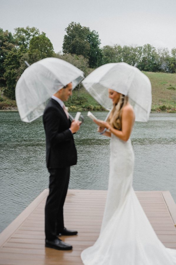bride and groom private vow reading dock clear umbrellas