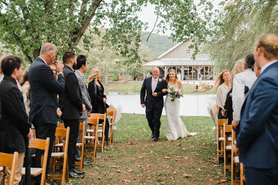 bride walking down aisle with father guests crying big spring farm
