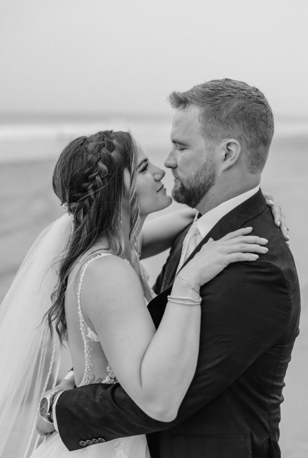 black and white first-look wedding day bride and groom portrait hugging