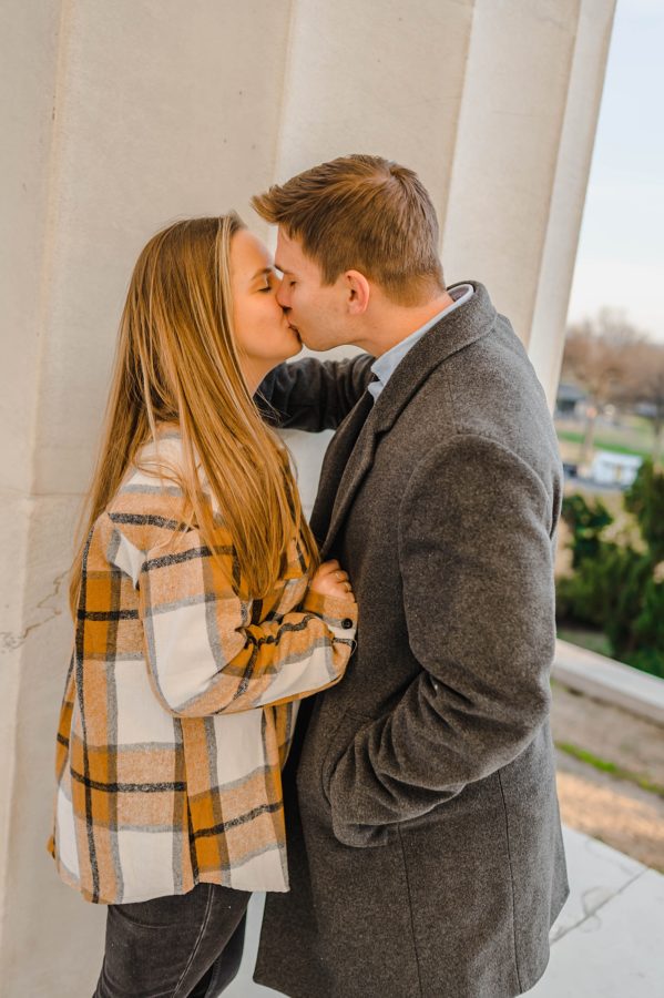engaged couple kissing girl holding guy