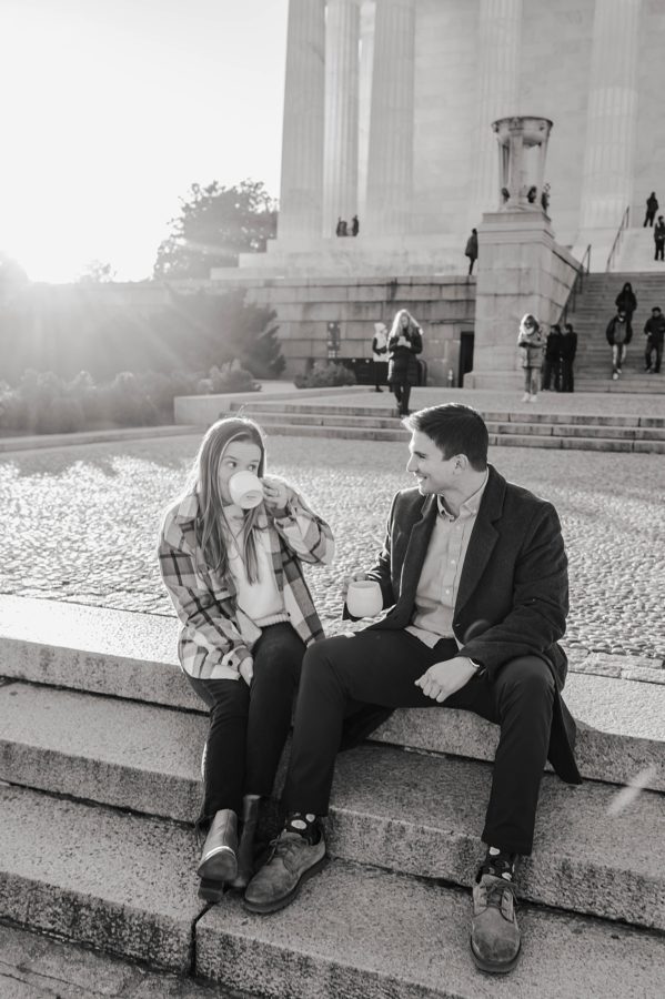 black and white lincoln memorial winter engagement couple smiling girl drinking