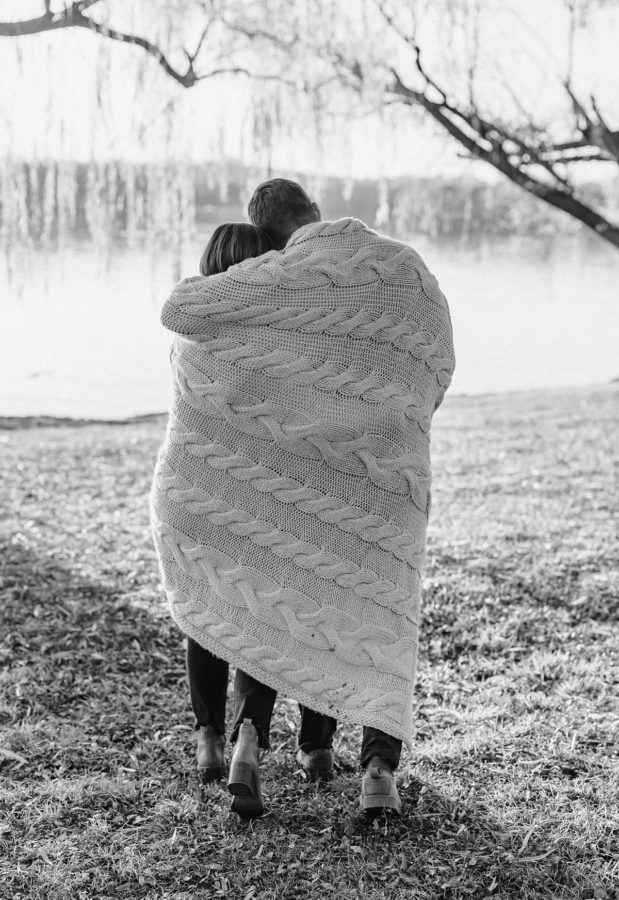 black and white knit blanket couple walking hugging