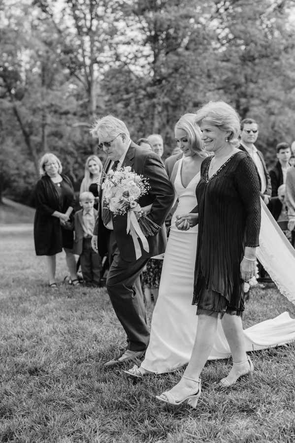 black and white bride walking down the aisle smiling
