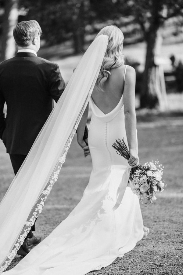 black and white wedding dress couple holding hands