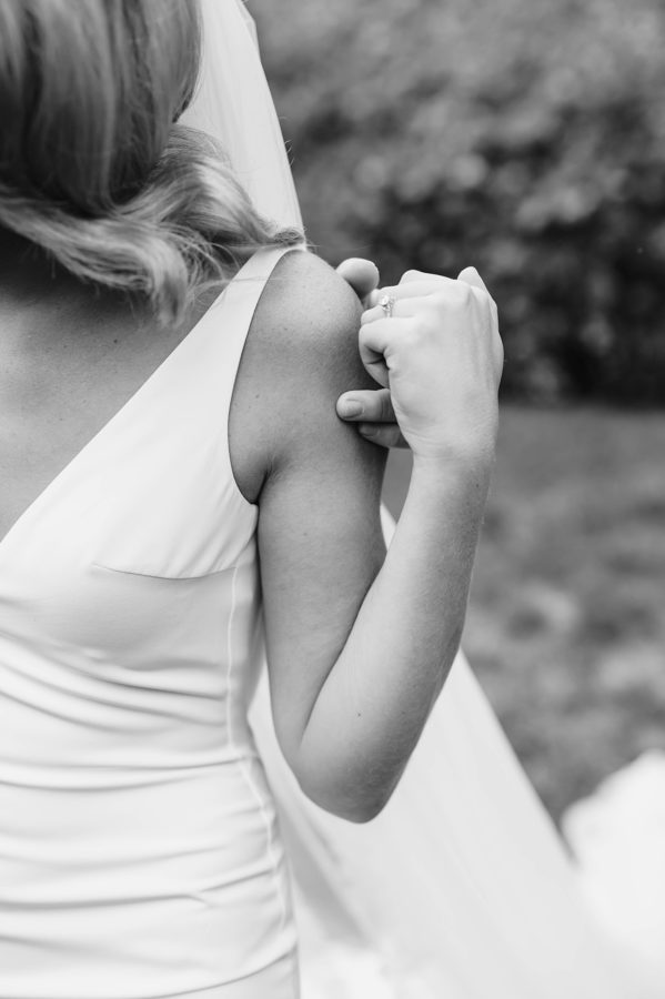 black and white wedding dress details bride holding hands