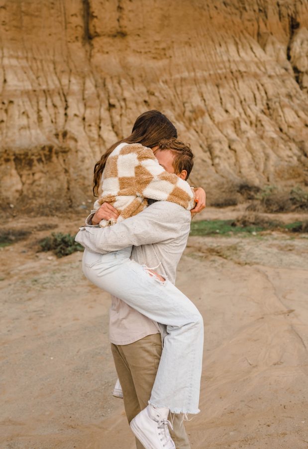 guy holding girl couple hugging neutrals