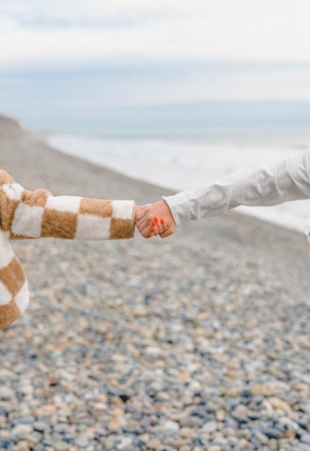 couple holding hands pebble beach