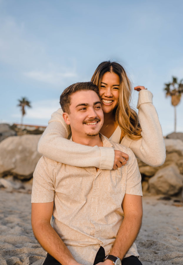 calafia beach engagement couple smiling hugging