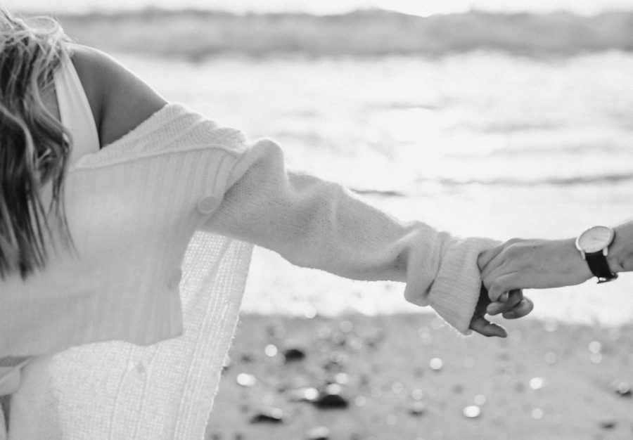black and white calafia beach engagement couple holding hands details