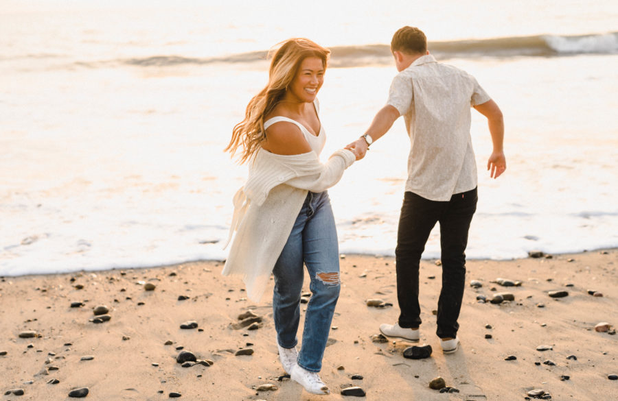 calafia beach engagement couple holding hands neutral tones 