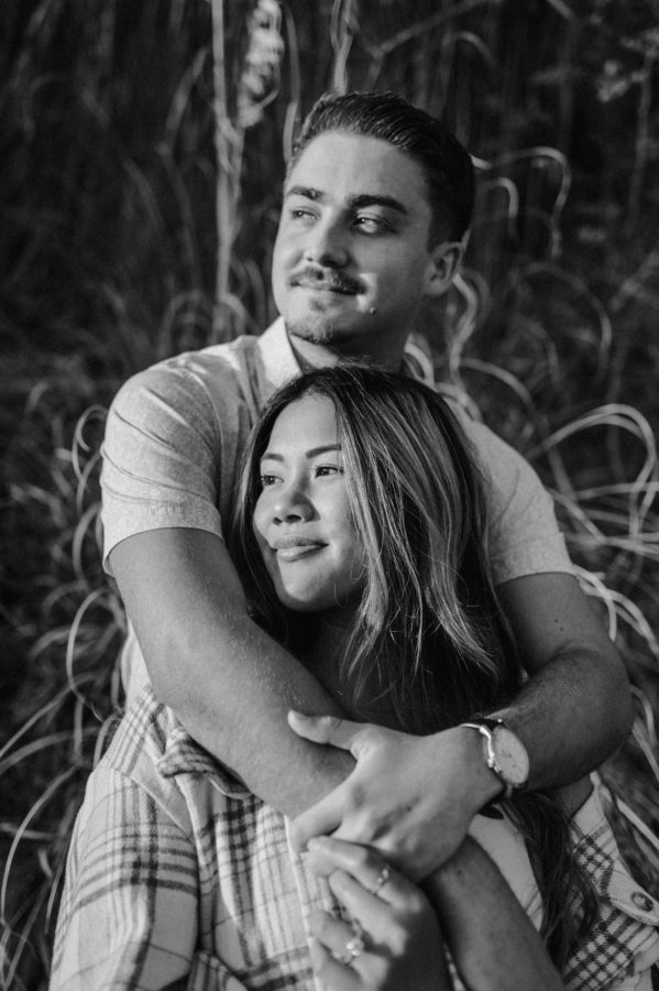 black and white portrait couple hugging smiling golden hour