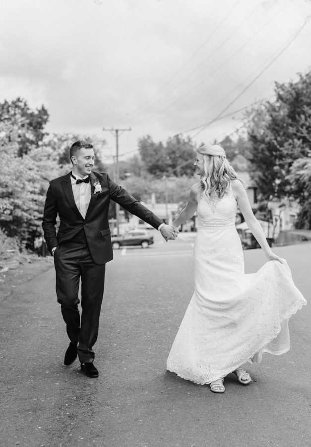 black and white middleburg garden wedding bride and groom walking holding hands