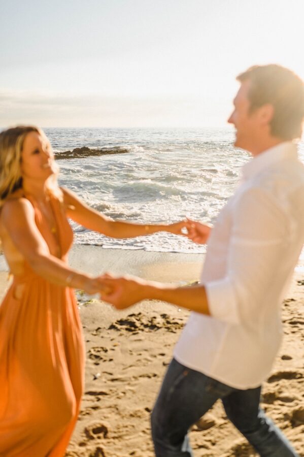 couple dancing on beach backgrounds in focus