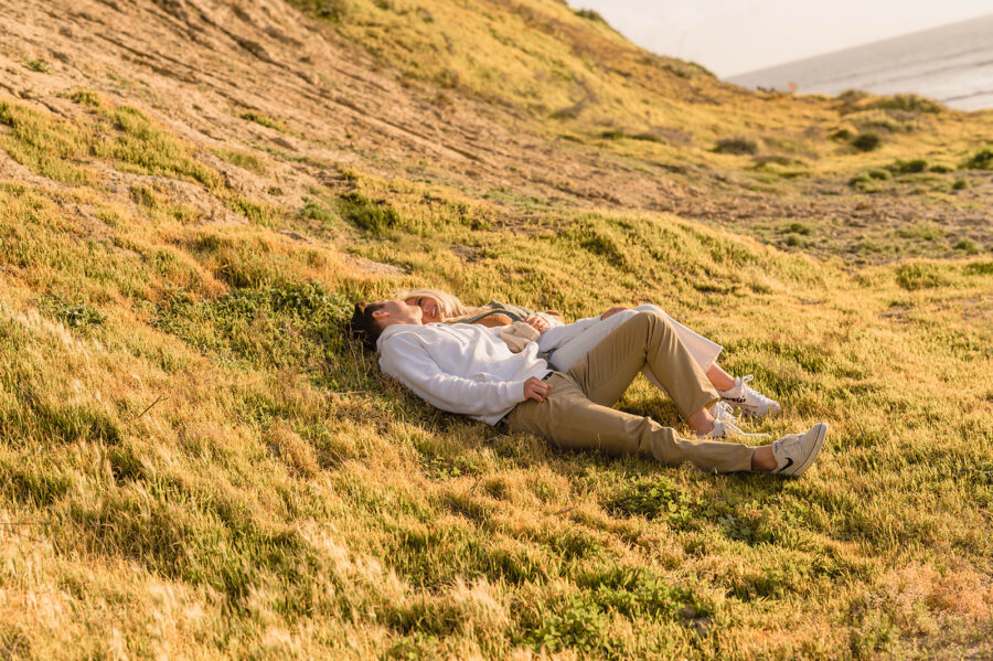 couple laying on the grass