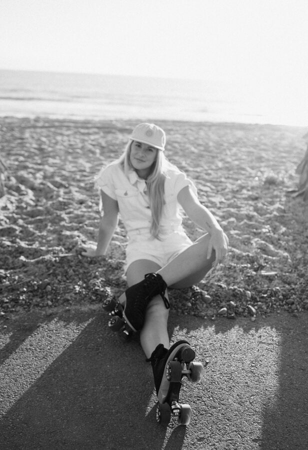 skater girl sitting on the sand in black and white 