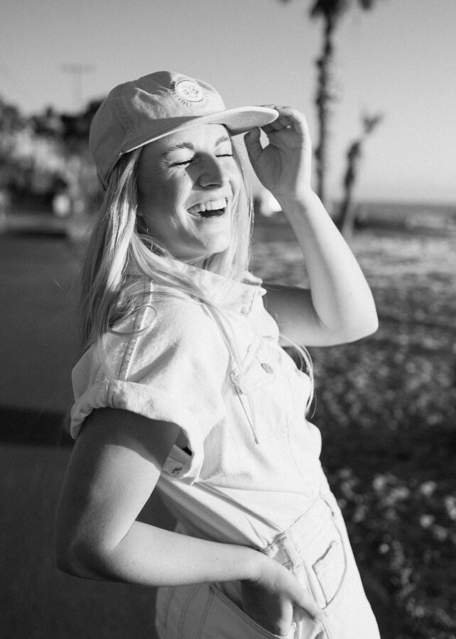 B&W girl with hat laughing 