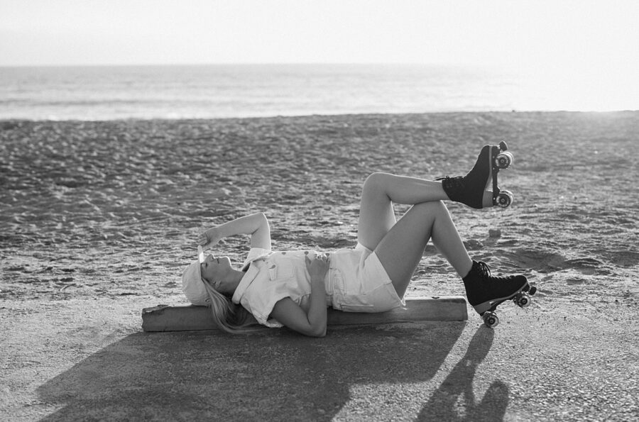 girl lays on the ground in roller skates