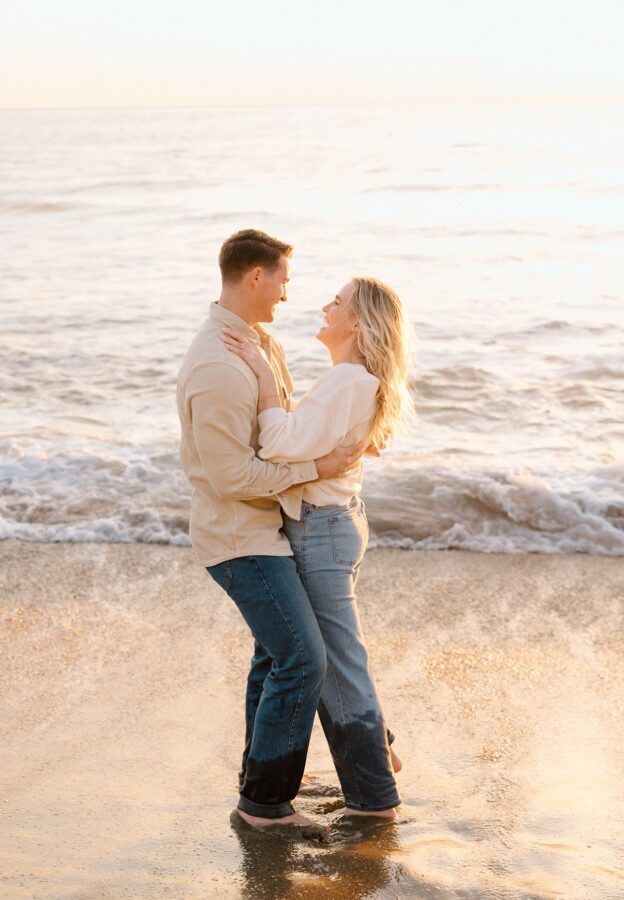 couple laughing by the ocean 
